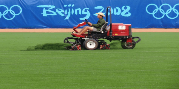 a man mowing riviera grass at the beijing olympics